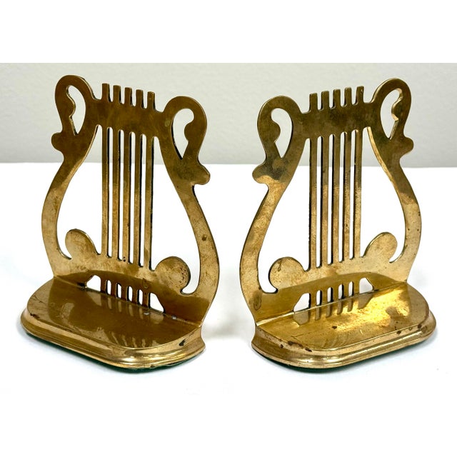 Vintage solid brass lyre motif bookends. Lovely patina.