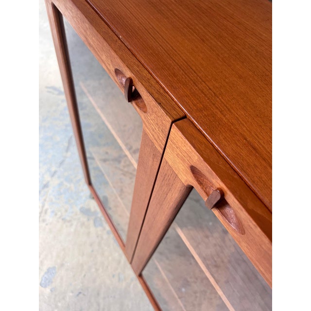 This display cabinet is a truly exceptional design by H.W. Klein for the premium Danish manufacturer Bramin and a prime...