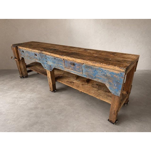 Exceptional and unusually large antique primitive carpenter's workbench with beautifully aged blue paint, massive hand-...
