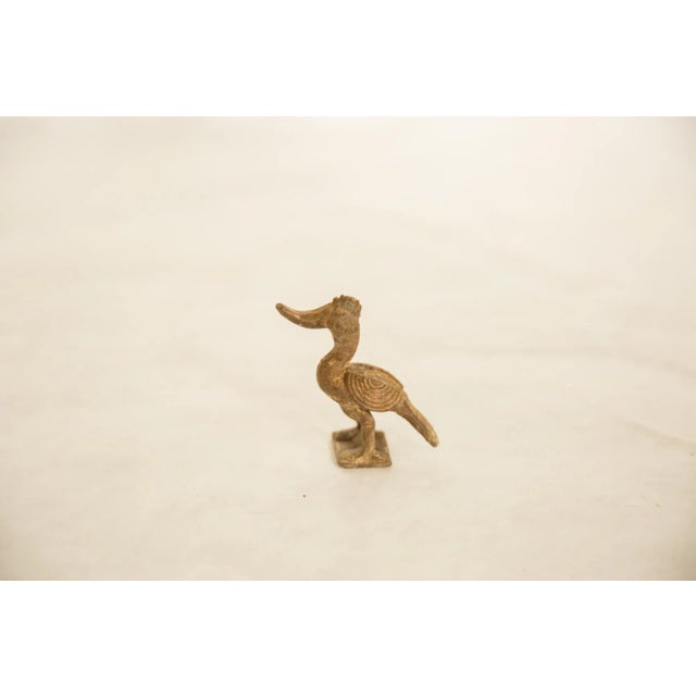 :: Vintage handmade African Bronze Curved Beak Bird. Circa mid 20th century and possibly older, this piece has such...