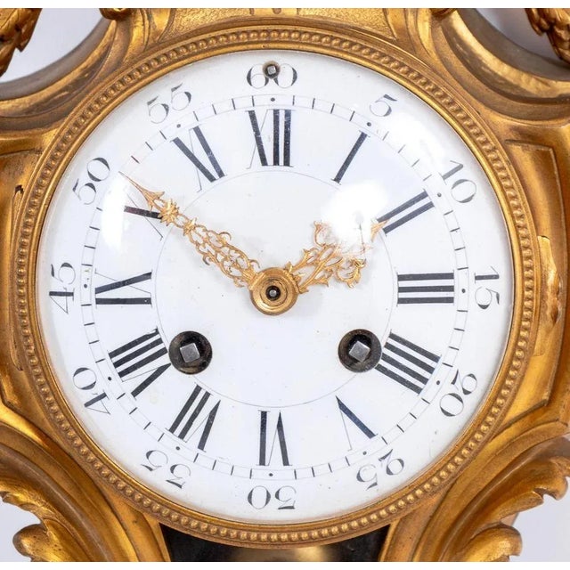 Louis XVI Style Gilt Bronze Cartel Clock, mid 19th century, the circular white enamel dial, with strike on bell movement,...