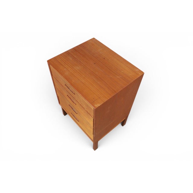 A compact and beautifully proportioned four-drawer teak chest, designed by Nils Jonsson in his iconic "Domi 4" model. A...