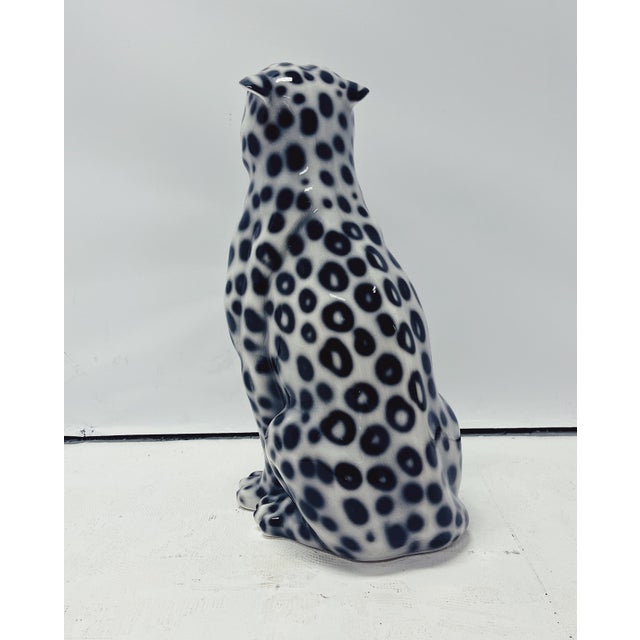 Unique handmade statue of a snow leopard. This Hollywood Regency statue, crafted from hand-painted ceramic and made in...