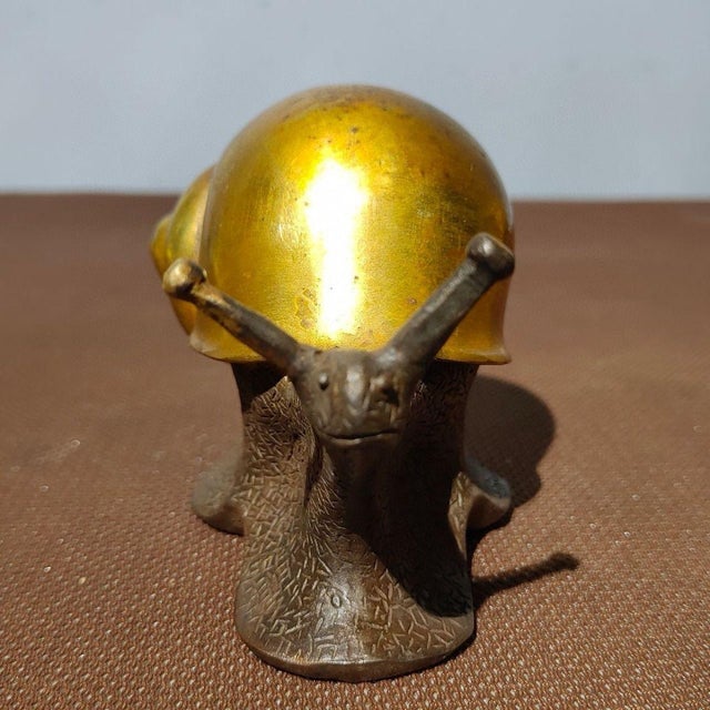 This charming vintage Chinese sculpture features a finely cast bronze snail, finished with a bright gold (gilt) wash on...