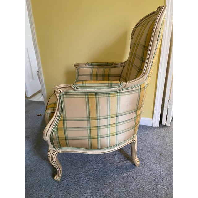 Magnificent vintage arm chair with floral sculpted wood frame reupholstered in yellow green silk plaid with green welt. A...