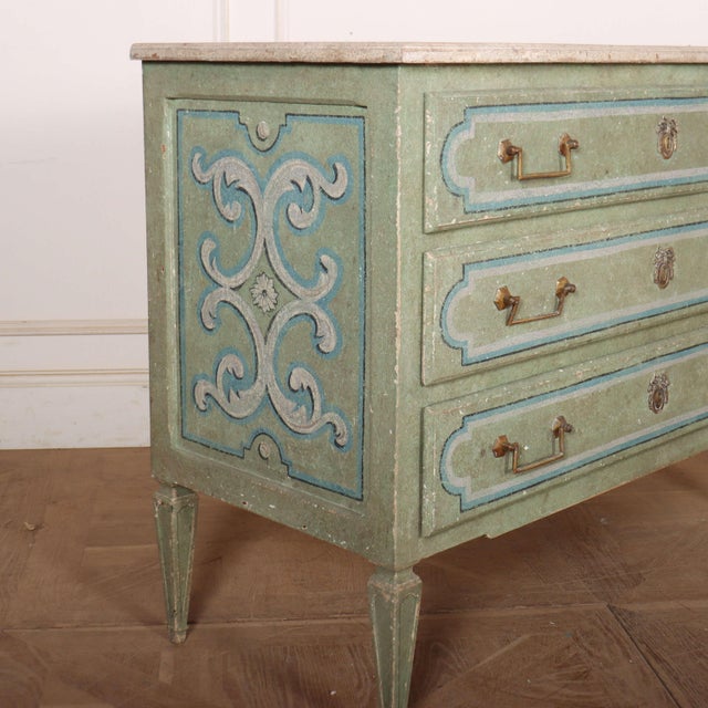 Pretty late 19th century Italian painted three drawer pine commode with a faux marble top. 1890. This piece is designed in...