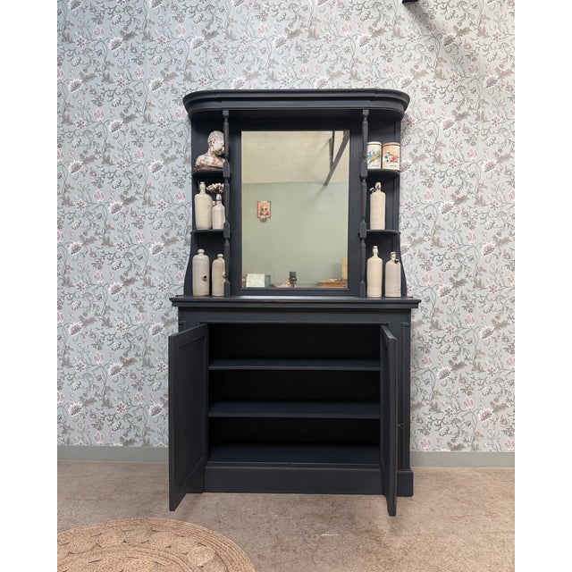 This imposing napoleon iii bistro cabinet dates from the late 19th century. Standing 2.30 meters tall, it is distinguished...