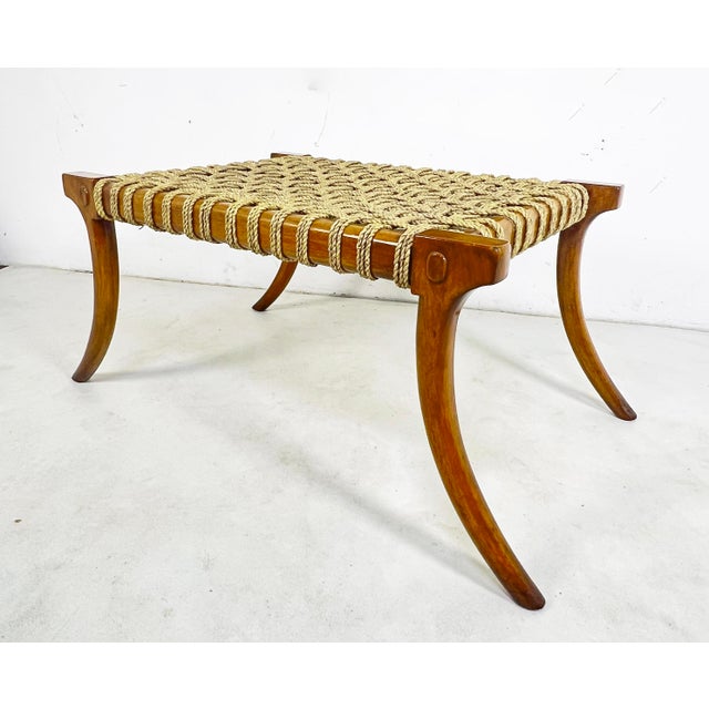A large Klismos style bench in lacquered birch with woven sea grass seat. This classic Greek design originated in the 5th...