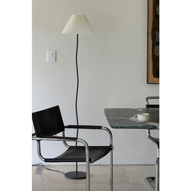 Sculptural wavy floor lamp with pleated cream shade. Standard bulb. Lamp is in working condition. Material Metal Fabric...