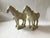 A pair of Tang dynasty style horse figures carved in a pale cream marble with buff tone and light natural veining. The...