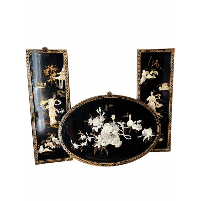 A striking three-piece decorative wall grouping featuring two slender rectangular figural panels and a broad oval floral...