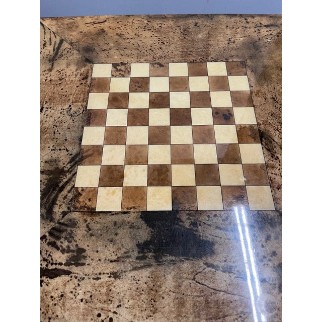 An Aldo Tura goatskin game table made in the 1970s in Italy. Table has 4 sliding drawers with brass ashtrays inserted into...