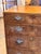 Walnut two over three chest of drawers with simple molded drawer fronts and pierced brass pulls. The top has a molded...