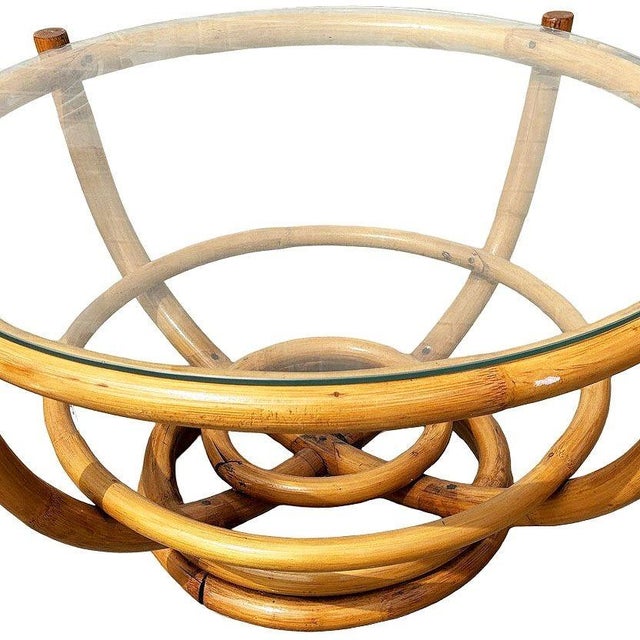 Restored Mid-century Four-pole rattan coffee table with stacked rattan round base. The 4 rattan poles organically branch...