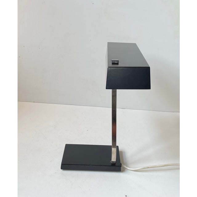 Very similar to Kaiser Leutchen's model 6878 comes this unusual architecturally clean, strict and minimalistic desk lamp...