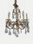 A striking French Rococo Revival chandelier combining sculptural cast bronze metalwork with dramatic hand-cut crystal...