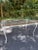 A vintage five-piece garden dining set featuring a rectangular glass-top table and four coordinating side chairs. The...