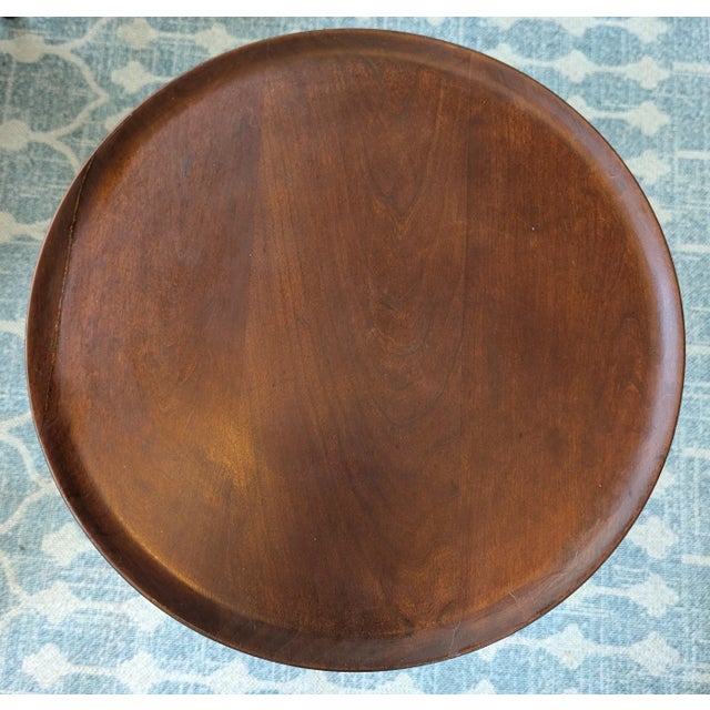 This mahogany Colonial reproduction side table features a tripod pedestal base, cabriole legs with lovely pad feet, and a...