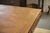 A rectangular table from the 1940s. The veneered top features a geometric design and is framed by a simple border. The...