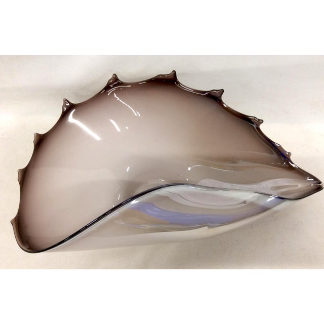 Capturing light in its lucid amethyst hues, this magnificent art glass sculpture illuminates its surroundings, instantly...
