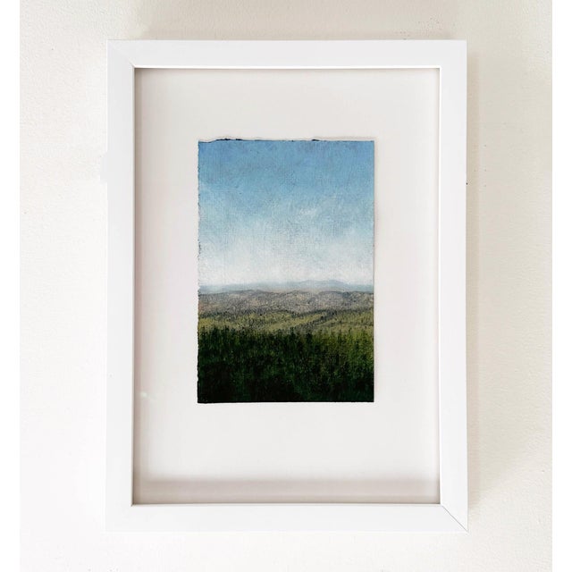 This oil painting on paper captures a serene landscape, featuring a vast horizon where rolling hills meet a clear blue...