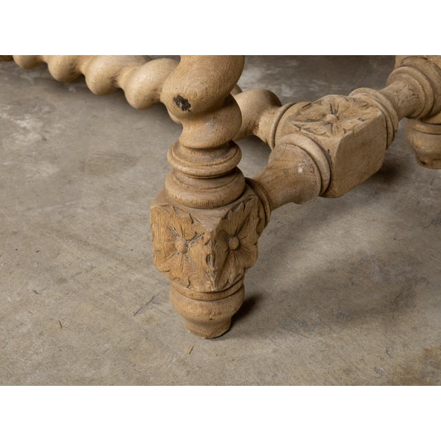 An English Turn of the Century bleached wood bench from circa 1900 with barley twist base and custom upholstery. This...