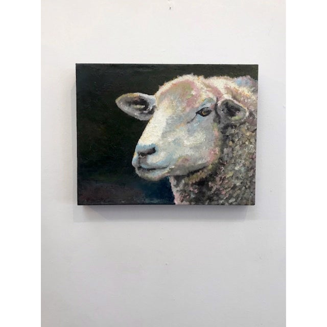 This artwork features a close-up of a sheep, its textured wool rendered with a blend of soft colors that evoke a sense of...