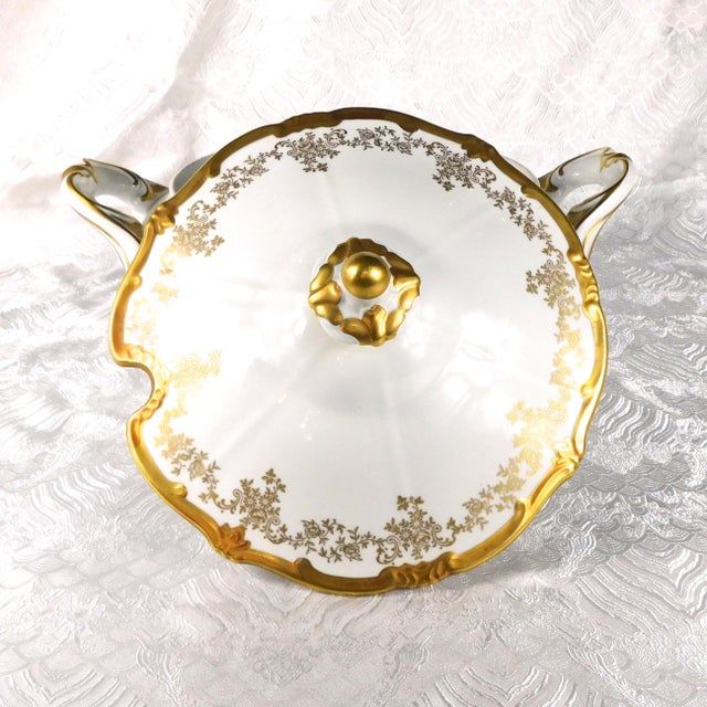 This is a very large soup tureen by Weimar in pattern 14051. The tureen is white and footed with a lot of gold trim and...