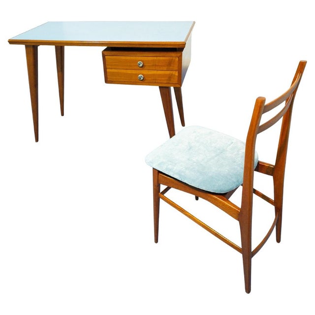 Elegant Italian writing desk and chair set dating to the 1950s, crafted in cherry wood with refined mid-century lines. The...