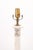 A refined pair of marble column lamps featuring classical Louis XVI wreath ornamentation and stepped bases. The...