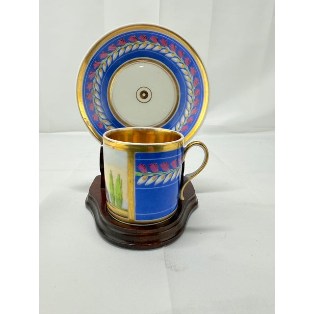 This exquisite 19th-century Neoclassical cup and saucer set represents the epitome of fine French porcelain craftsmanship,...