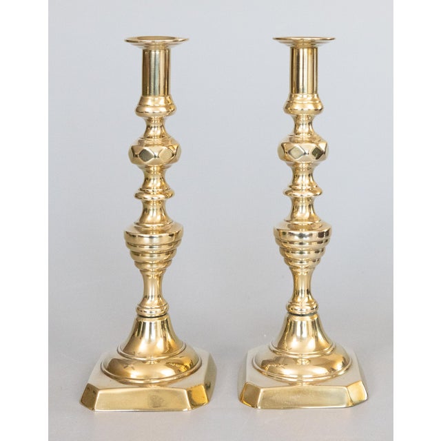 A fine pair of antique 19th-Century English solid brass push-up ejector candlesticks with beehive and diamond motifs,...
