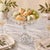 A substantial vintage clear pressed-glass pedestal compote featuring the traditional Daisy & Button pattern. The shallow...