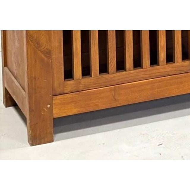 Jean Touret & Les Artisans de Lozère Chestnut slatted sideboard with four doors. 1960s. Dimensions: Height: 200 cm Width:...