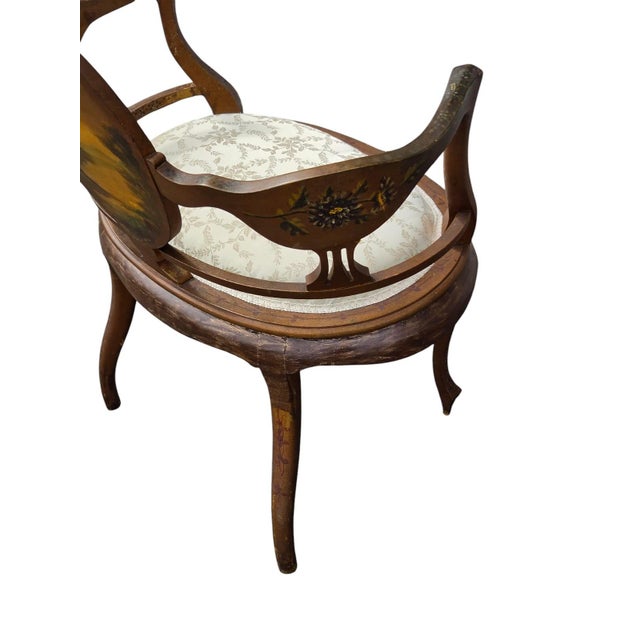 Beautiful French Louis XV-style armchair featuring an elegant curved wooden frame and charming hand-painted details. The...