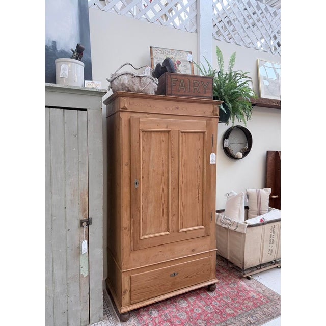 This 19th‑century English pine armoire is a beautiful example of practical country furniture elevated by time. Built from...
