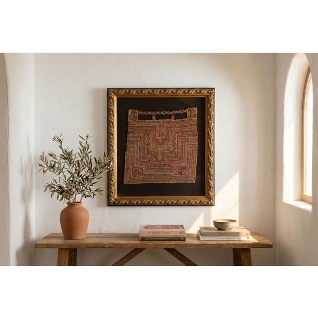 Add a touch of cultural richness and intricate artistry to your home with this framed antique Hmong textile fragment....