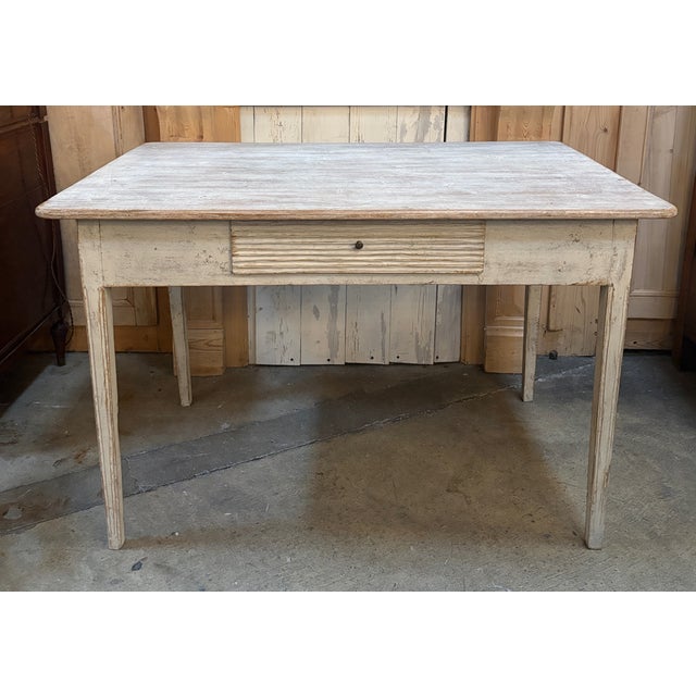 19th Century Gustavian Style Swedish writing desk. Lovely Swedish cream white color. Fluted tapered legs support an apron...