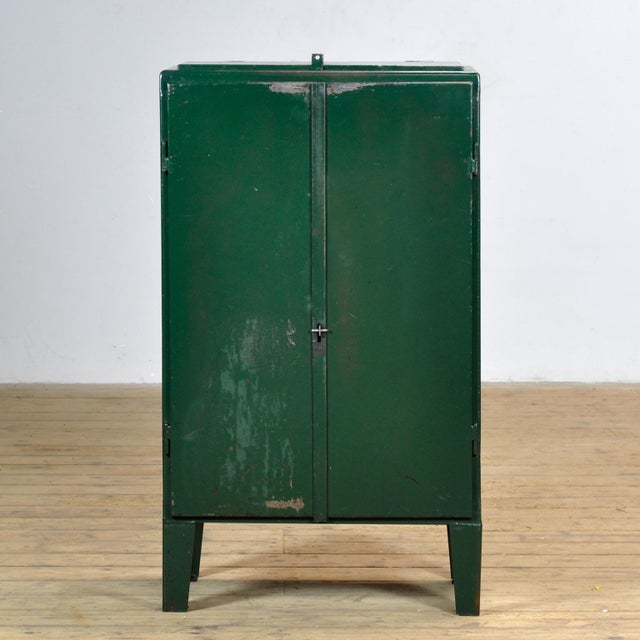 Industrial cabinet from the 1970s, made of iron. This robust eye-catcher has a practical top flap and offers a surprising...