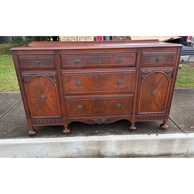 Vintage Buffet in a Red Flame Mahogany Wood with Ample Storage Five Drawers and Two Door Cabinet Space .