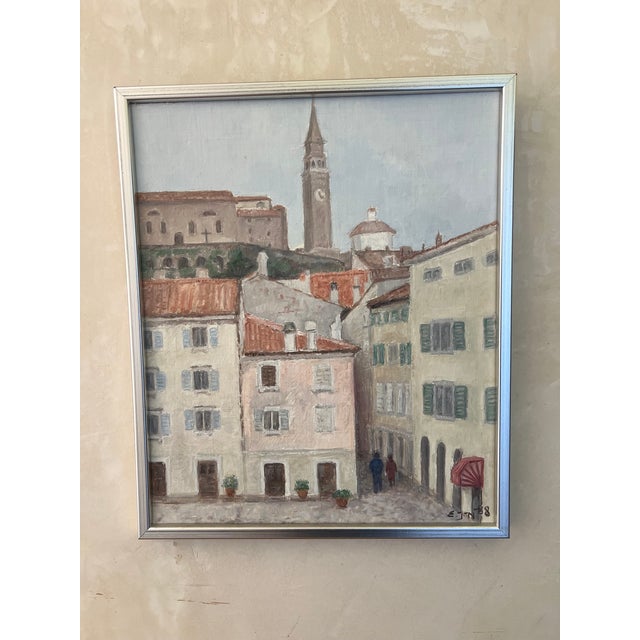 City scape painting of the seaside town of Piran in what is now Slovenia, signed by Swedish artist Ella Nilsson. Framed in...