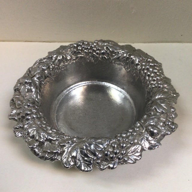 The Artnur Court grape and leaf wine coaster is made of aluminum and the measurements are 6 1/4 inches wide by 2 1/4...