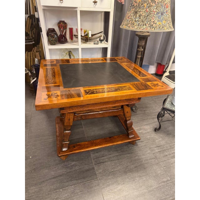 18th-century trestle table with slate top and marquetry. The square tabletop features an authentic, dark slate inlay. The...