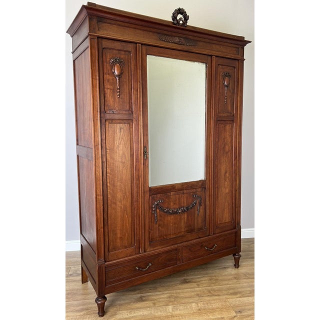 An elegant Antique French walnut mirrored wardrobe showcasing timeless craftsmanship, refined proportions and beautiful...