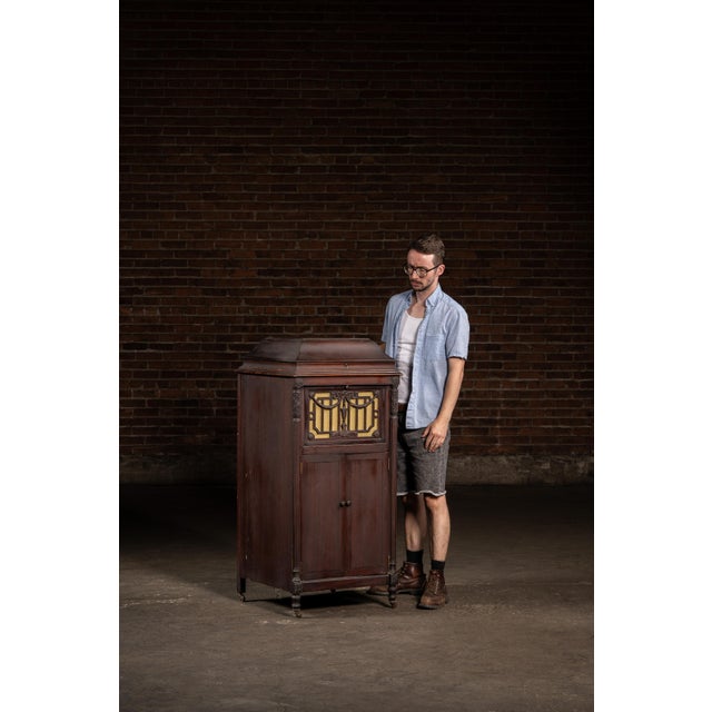 c. 1920s; Silvertone (Sears, Roebuck & Co.) - Chicago Mahogany floor-standing Silvertone phonograph featuring ornate...