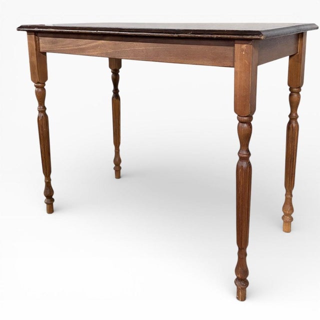 A charming pine and oak console table with a simple, timeless form and classic turned legs. The warm-toned timber top sits...