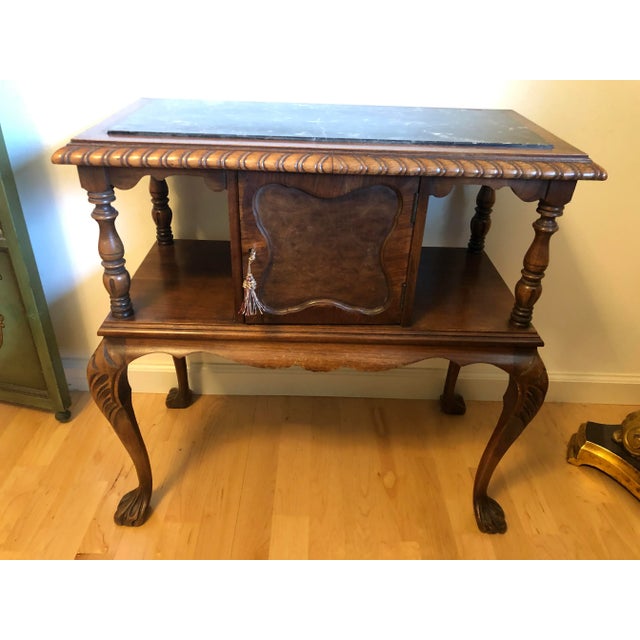 Rare early 1900s table stand. Beautifully hand-carved tiger oak cabinet with attached dark-veined stone marble top. Single...