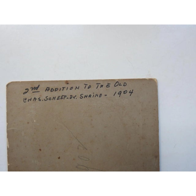 1904 albumen photograph mounted on gray cardboard backing. Group of carpenters framing out the addition to the Old Charles...