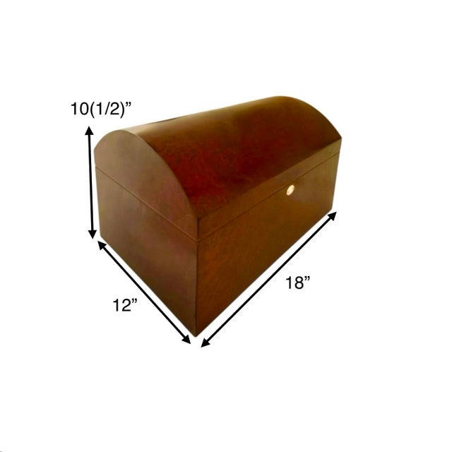 A handsome XL dome-top humidor in rich burl wood veneer, fitted with Spanish cedar trays and built to hold up to 250...