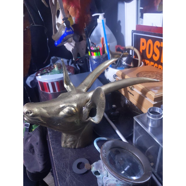 ​Material: Heavy, solid cast brass with a textured face and smooth, polished horns. ​Condition: Excellent vintage...